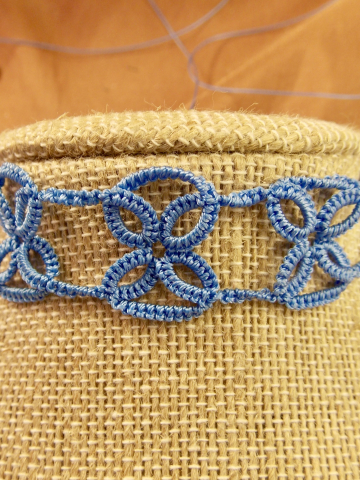 Close-up view of the tatted lace intersections forming delicate X patterns.