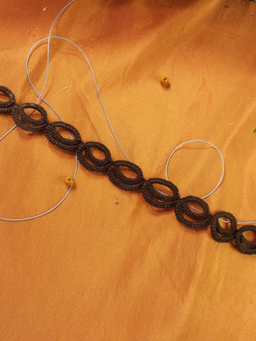 Detail of Pulsebound's lace rings highlighting precise tatting work.