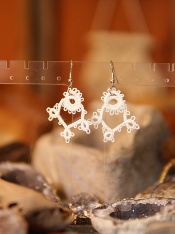 Elegant tatted earrings evoking early 20th-century design