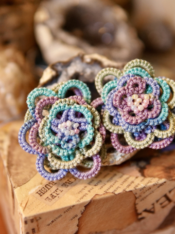 Hand-tatted floral earrings in shades of pink, lavender, aqua, and green.