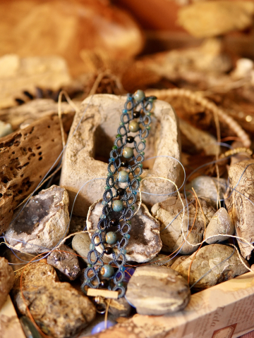Bohemian backdrop of geodes and cement featuring Stoneveil tatted bracelet