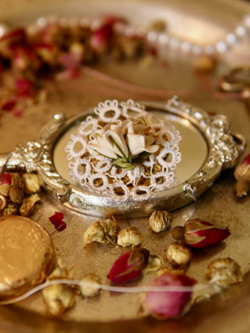 Lace flower pin with cream blooms in vintage warm light