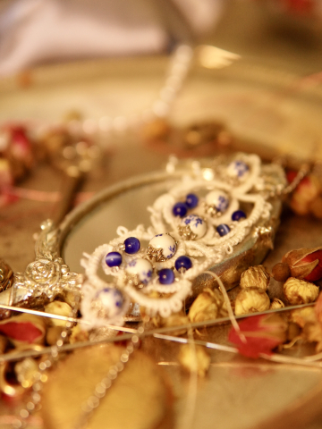 Blue and white lace bracelet displayed in vintage warm light