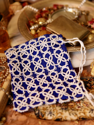 Blue linen purse with hand-tatted white lace overlay.