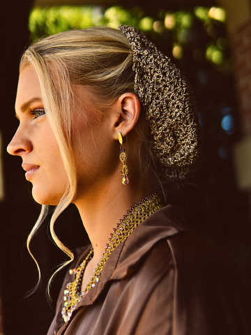 Gold lace necklace with iridescent drops on model