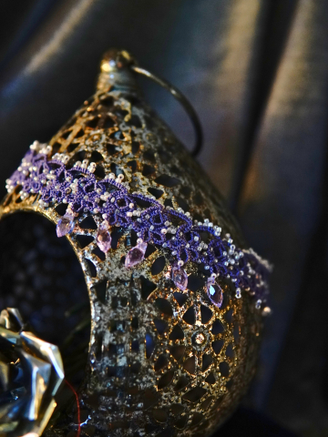 Detailed view of purple lace motifs with clustered seed beads