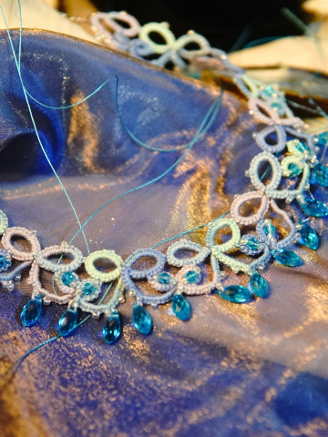 Aqua crystal drops hang from tatted loops in ocean colors