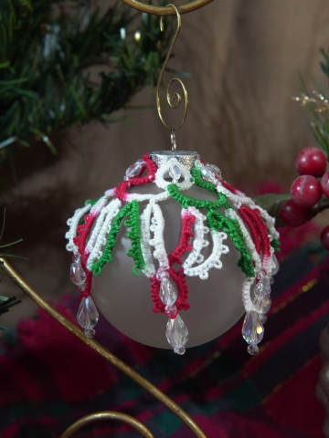 Red, green, and white lace ornament with crystal drops