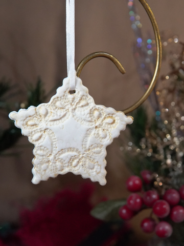 Light gold star ornament with delicate tatted-lace texture
