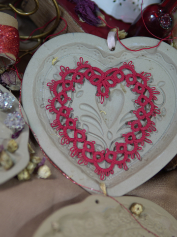 Red tatted Valentine heart in styled flat lay