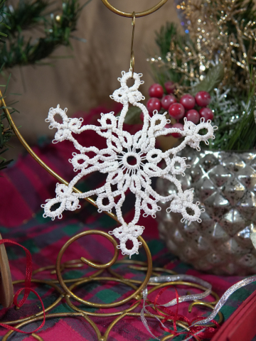 Intricate white tatted snowflake hanging ornament