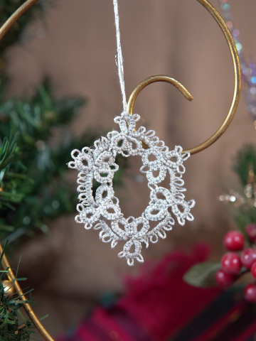 Handmade silver tatted lace oval ornament with picots and rings