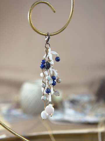 White tatted lace keychain with lapis and crystal beads on vintage book