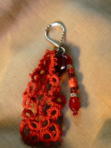 Detailed view of red lace keychain with heart bead