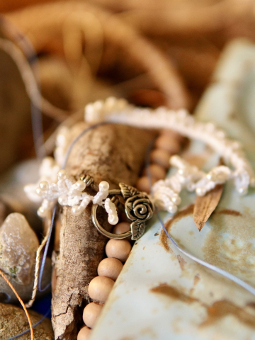 White tatted bracelet from Wanderthread line displayed on Bohemian backdrop